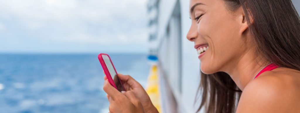 Woman on cruise ship looking at mobile phone